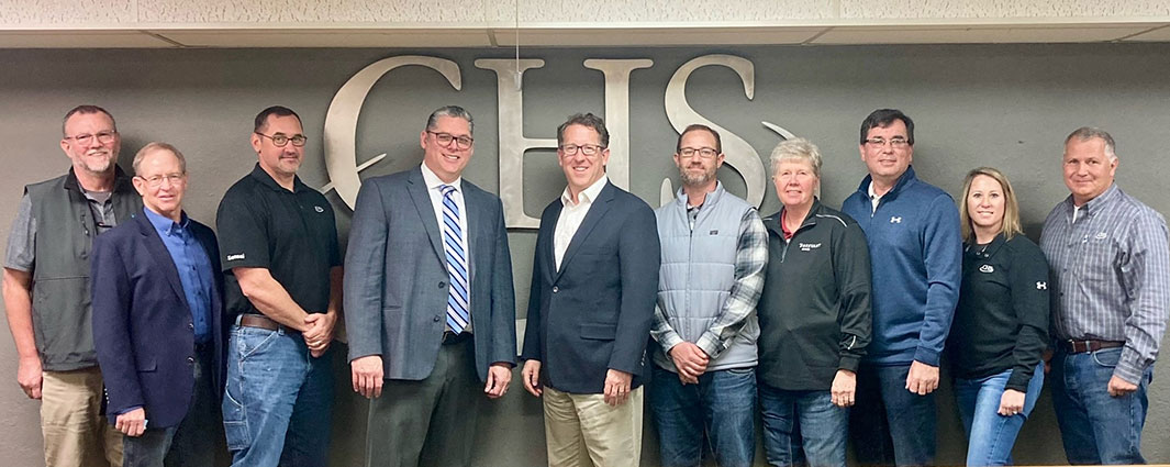 group of people in front of CHS logo